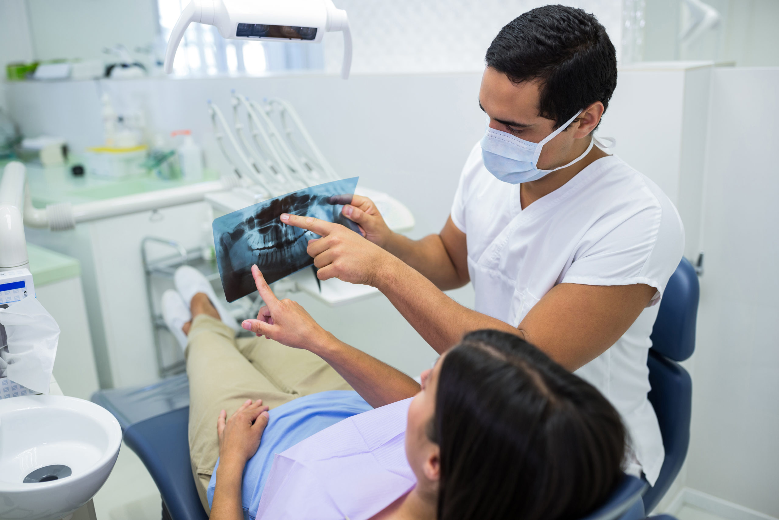 Rubicare dental provider examining x-ray with young woman.