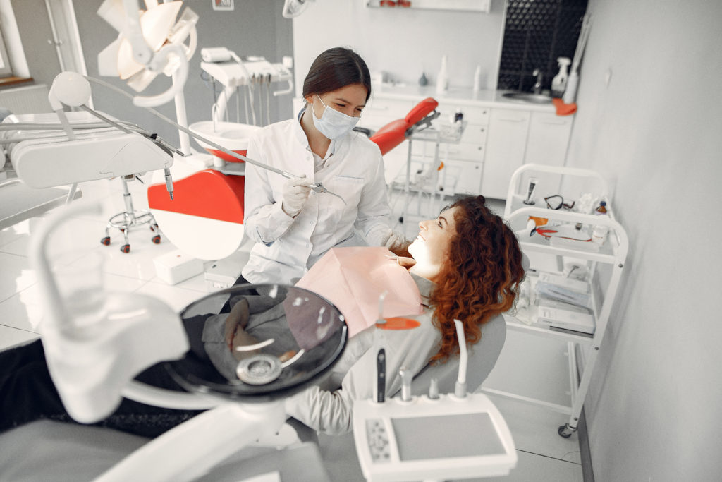 Rubicare for Business. Woman in dental chair smiles at Rubicare provider.