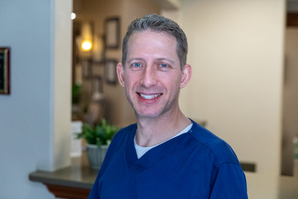 Dr. Josh Muir, an expert in dental implants, showcasing how patients can save with the Rubicare Health Savings Plan at the Montana Center for Implants and Dentures.